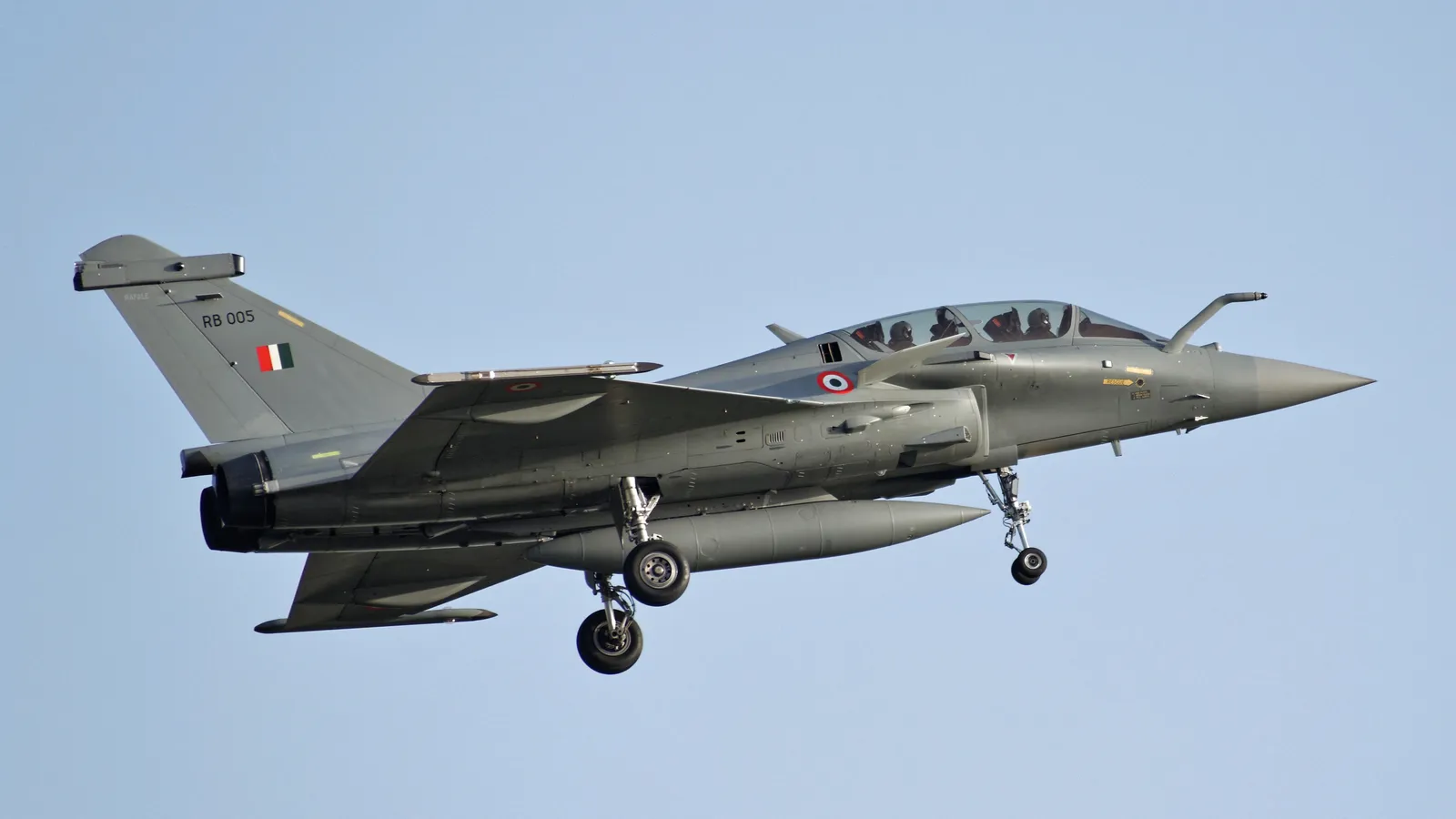 An Indian Air Force Rafale flies with external fuel tanks and air-to-air missiles.